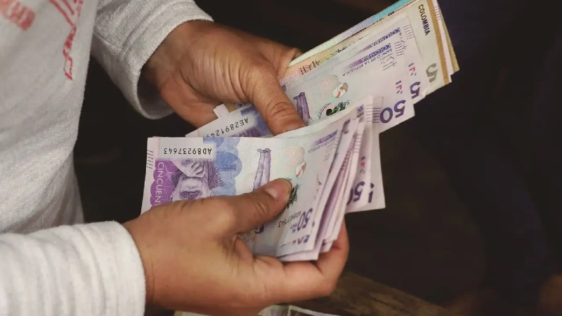 La imagen describe una persona contando billetes, recreando un préstamo recibido. Foto: Taken in Envigado